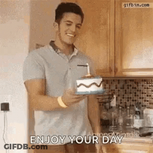A Man Is Holding A Birthday Cake With A Candle In It And Smiling . GIF