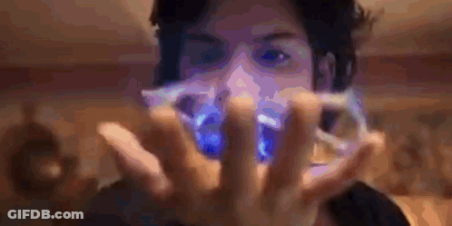 A Man Is Holding A Blue Object In His Hands GIF