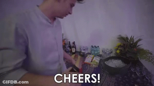 A Man Is Holding A Bottle Of Champagne And Saying `` Cheers '' . GIF