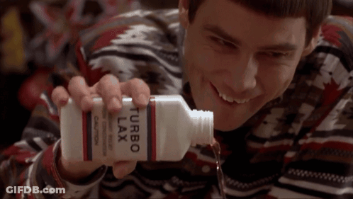 A Man Is Holding A Bottle Of Turbo Lax And Smiling GIF