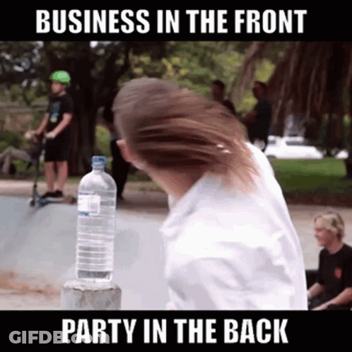 A Man Is Holding A Bottle Of Water In Front Of A Sign That Says Business In The Front GIF