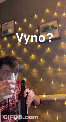 A Man Is Holding A Bottle Of Wine And A Glass With The Word Vyno Written Above Him GIF