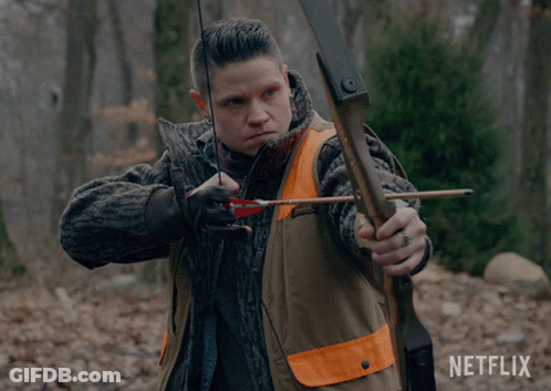 A Man Is Holding A Bow And Arrow With A Netflix Logo In The Background GIF