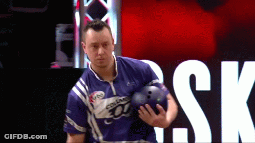 A Man Is Holding A Bowling Ball In Front Of A Sign That Says " Sk " GIF