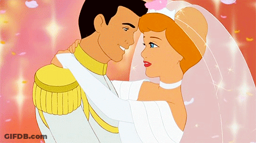 A Man Is Holding A Bride And Groom In His Arms GIF