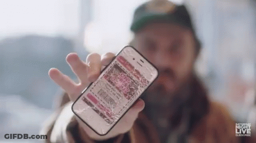 A Man Is Holding A Broken Cell Phone In His Hand And It Says Saturday Night Live On The Bottom . GIF