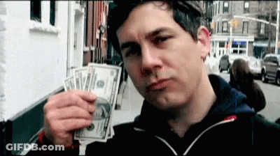 A Man Is Holding A Bunch Of Money In His Hand And Making A Face . GIF