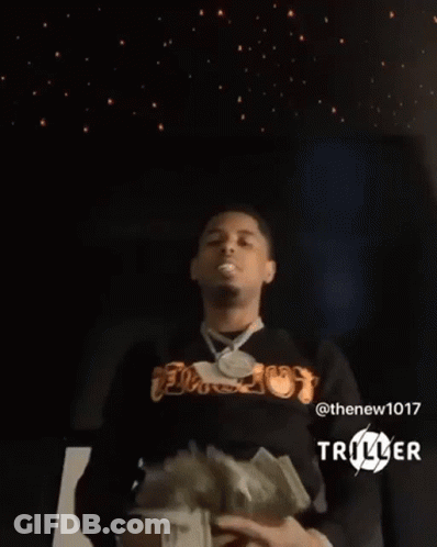 A Man Is Holding A Bunch Of Money In His Hands In Front Of A Starry Sky . GIF