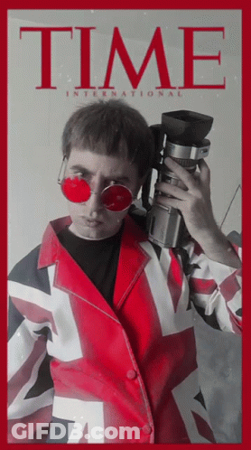 A Man Is Holding A Camera On A Time Magazine Cover GIF