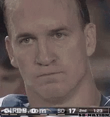 A Man Is Holding A Can Of Soda In Front Of His Face During A Game . GIF