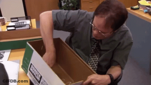 A Man Is Holding A Cardboard Box With A Label That Says Business Mix Ltd. GIF