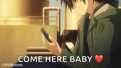 A Man Is Holding A Cell Phone And The Words Come Here Baby Are Above Him . GIF
