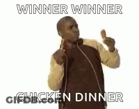 A Man Is Holding A Chicken Wing In His Hands . GIF