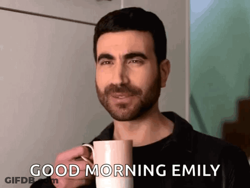 A Man Is Holding A Cup Of Coffee And Saying Good Morning Emily . GIF