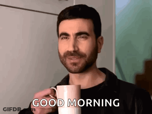 A Man Is Holding A Cup Of Coffee And Saying `` Good Morning '' . GIF