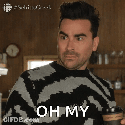 A Man Is Holding A Cup Of Coffee And Says " Oh My " GIF