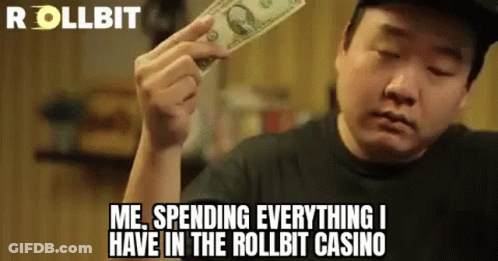 A Man Is Holding A Dollar Bill In His Hand And Saying `` Me Spending Everything I Have In The Roll Bit Casino '' . GIF