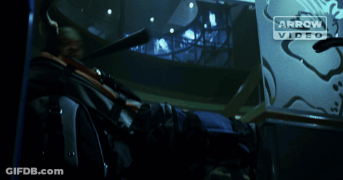 A Man Is Holding A Fire Extinguisher In Front Of An Arrow Video Logo GIF