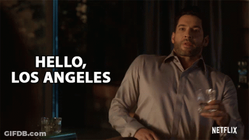 A Man Is Holding A Glass Of Whiskey And Saying Hello Los Angeles GIF