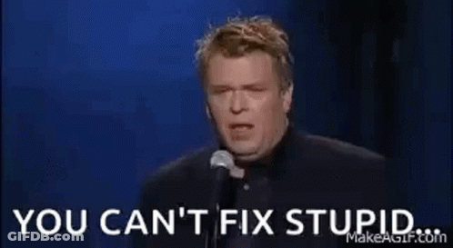 A Man Is Holding A Glass Of Whiskey In Front Of A Microphone And Says `` You Can 'T Fix Stupid '' . GIF