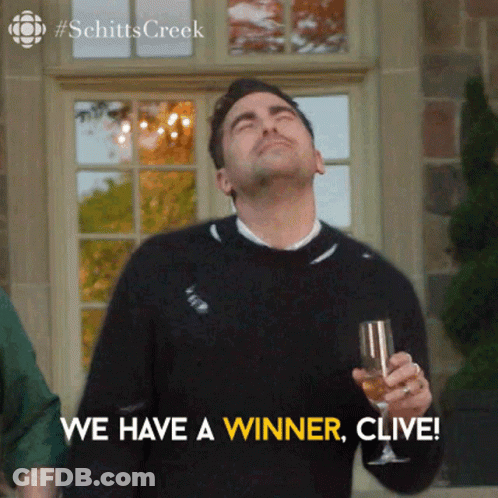 A Man Is Holding A Glass Of Wine And Saying We Have A Winner , Clive . GIF