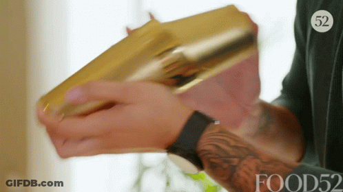 A Man Is Holding A Gold Shaker With The Number 52 On His Shirt GIF