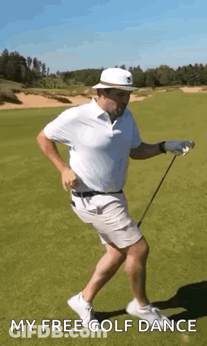 A Man Is Holding A Golf Club And Dancing On A Golf Course . GIF
