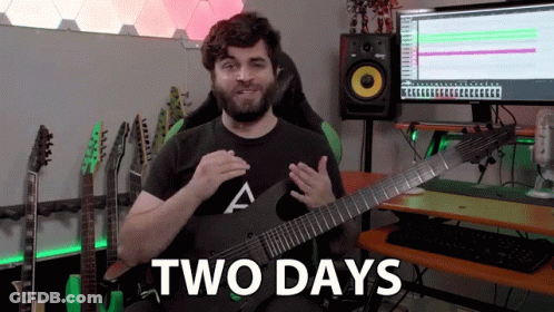 A Man Is Holding A Guitar In Front Of A Computer And Says " Two Days " GIF