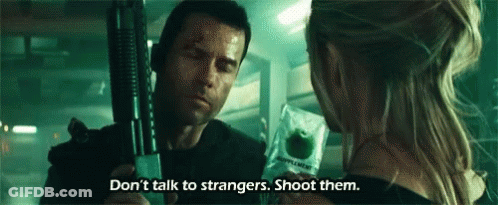 A Man Is Holding A Gun And A Woman Is Holding An Apple . GIF