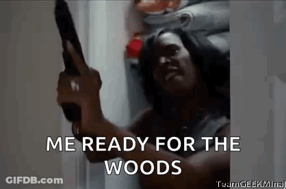 A Man Is Holding A Gun In A Refrigerator And Saying `` Me Ready For The Woods '' . GIF