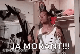 A Man Is Holding A Gun In A Room With The Words `` Ja Morant !!! '' Written On It . GIF