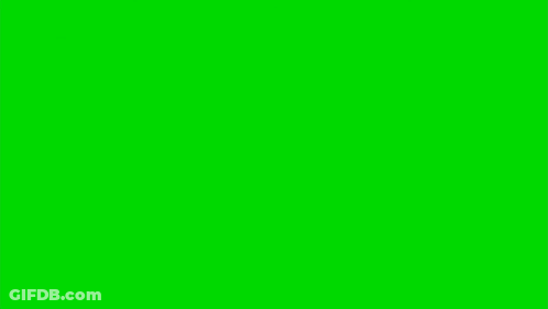 A Man Is Holding A Gun In Front Of A Green Screen GIF