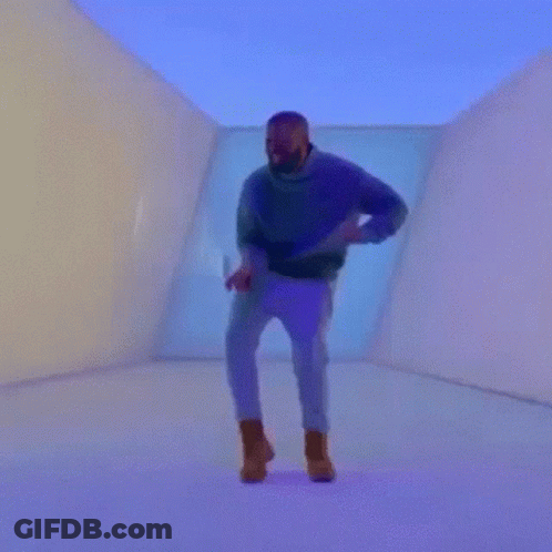 A Man Is Holding A Heart Shaped Tennis Racket In A Room GIF