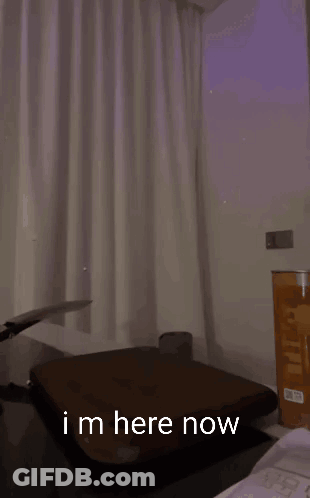 A Man Is Holding A Knife Over A Cutting Board And Says " Im Here Now " In The Corner GIF