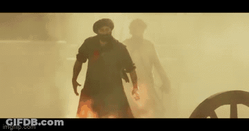 A Man Is Holding A Large Shield Over His Head In A Scene From A Movie GIF