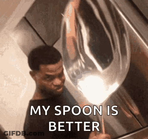A Man Is Holding A Large Silver Spoon And Says " My Spoon Is Better " GIF