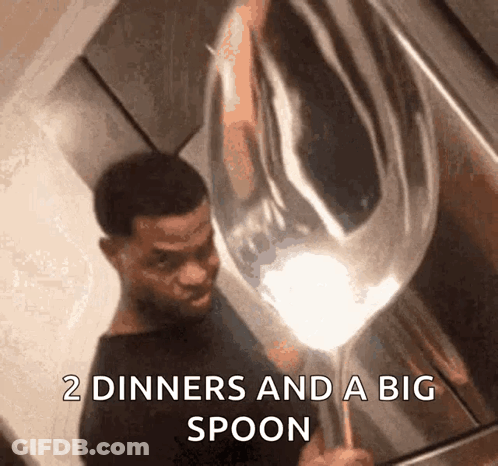 A Man Is Holding A Large Spoon That Says " 2 Diners And A Big Spoon " GIF