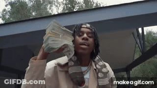 A Man Is Holding A Large Stack Of Money In His Hands . GIF