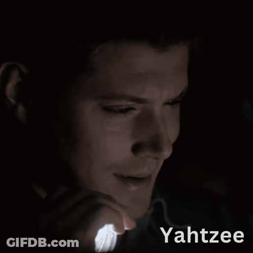 A Man Is Holding A Light In His Hand And The Word Yahtzee Is On The Bottom GIF