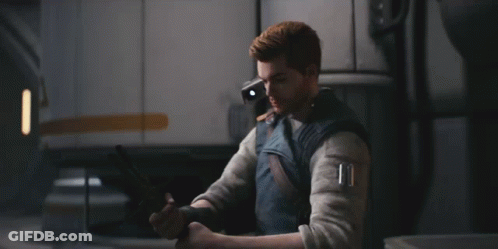 A Man Is Holding A Light Saber In A Room GIF