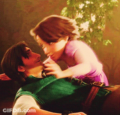 A Man Is Holding A Little Girl In His Arms GIF