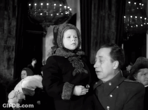 A Man Is Holding A Little Girl In His Arms GIF
