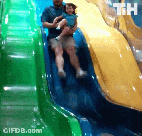 A Man Is Holding A Little Girl On A Slide And The Letters Th Are On The Bottom Of The Slide GIF