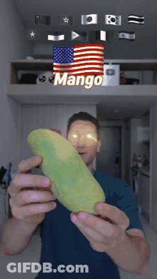 A Man Is Holding A Mango In Front Of A Flag That Says Mango GIF