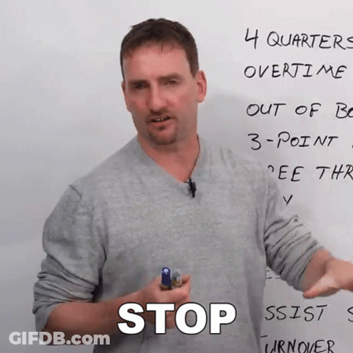 A Man Is Holding A Marker In Front Of A Whiteboard That Says Stop GIF