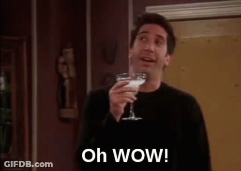 A Man Is Holding A Martini Glass And Saying `` Oh Wow ! '' GIF