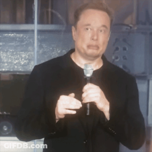 A Man Is Holding A Microphone And Making A Face GIF