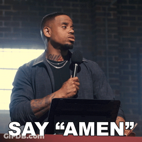 A Man Is Holding A Microphone And Says Amen GIF