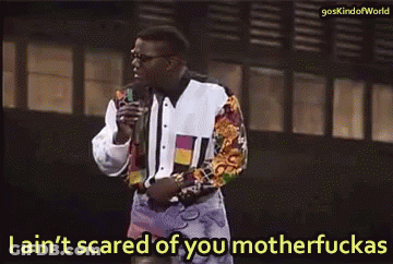 A Man Is Holding A Microphone And Says I Ain 'T Scared Of You Motherfuckas GIF