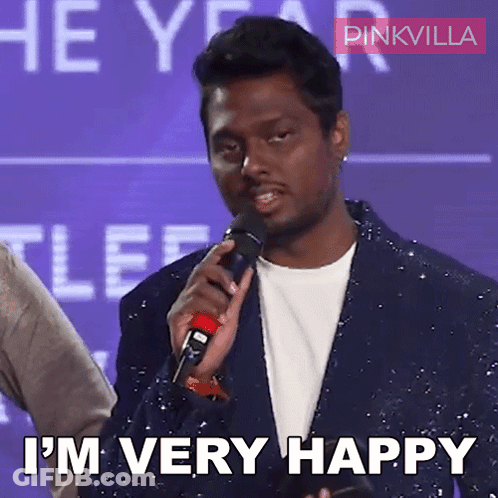 A Man Is Holding A Microphone And Says I 'M Very Happy GIF